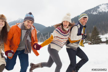 Happy couples friends running in snow Happy couples friends running in snow