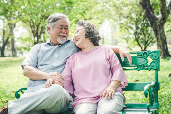 Happy elderly couple with lifestyle after retiree concept. Lovely asian seniors couple embracing together in the park in the morning.