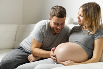 Happy father touching pregnant wife belly Free Photo