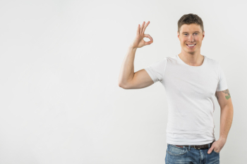 Happy man showing ok sign against white background Happy man showing ok sign against white background