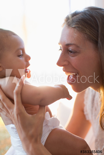 Happy mother holding baby son