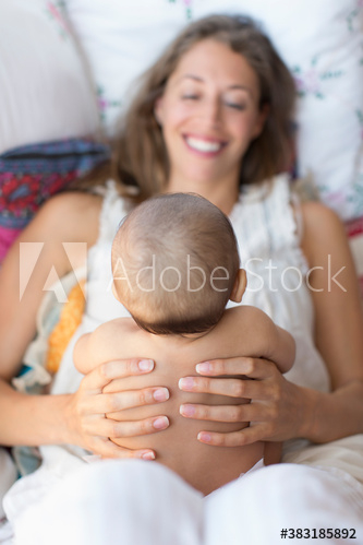 Happy mother holding baby son