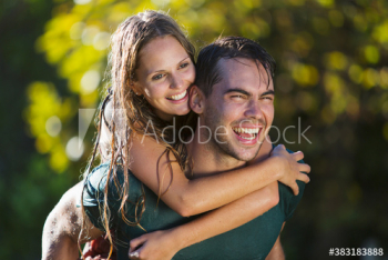 Happy playful young couple piggybacking Happy playful young couple piggybacking