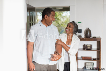 Happy senior couple holding hands at home Happy senior couple holding hands at home