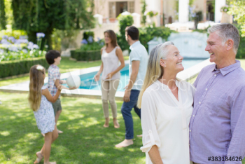 Happy senior couple with family in backyard Happy senior couple with family in backyard