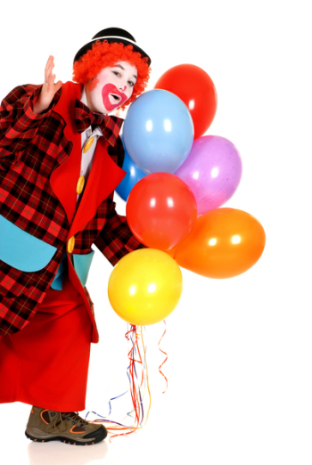 Happy smiling female clown, colorful dressed, studio shot on white background