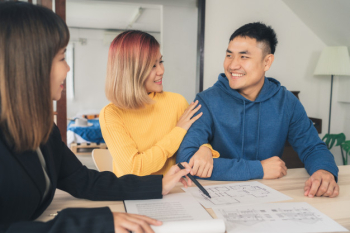 Happy young Asian couple and realtor agent Happy young Asian couple and realtor agent