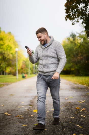 Happy young man walking through the park Free Photo Happy young man walking through the park Free Photo