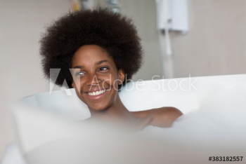 Happy young woman with afro enjoying bubble bath Happy young woman with afro enjoying bubble bath
