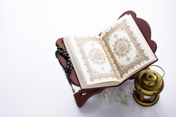 High angle opened quran next to candle Free Photo High angle opened quran next to candle Free Photo