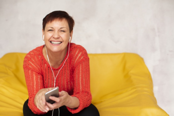 High angle senior woman listening music mock-up Free Photo