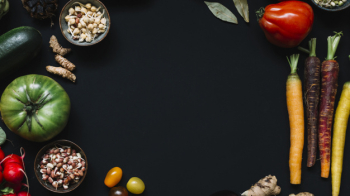 High angle view of various raw vegetables on black background