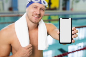 High angle young man at pool holding mobile Free Photo