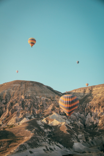Hot Air Balloons Floating Above Mountains Hot Air Balloons Floating Above Mountains