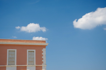 I love clouds. In this picture I like the contrast between complementary colors and between the geometric lines of the building and the smooth and fluffy white clouds 