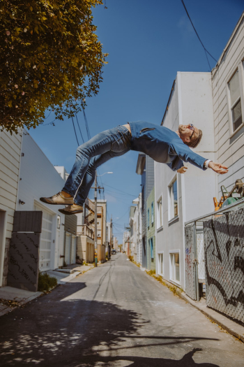 I shot this behind our house on Valencia St in the SF Mission District. I set up my tripod and a step ladder. I balanced myself on the top of the ladder and my friend took the shot. I then climbed down, removed the ladder, and captured a second image. Later, in Photoshop, I worked with two layers: 1. me and the ladder; and 2. the empty alley. I then used a layer mask to brush away the ladder, leaving my body hanging in mid-air. The concept was intended to illustrate the power of salvation, a gift from Jesus through which he works in our lives to rescue us from self-destruction.