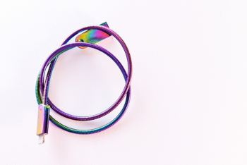 Iridescent Cable Wire On White Surface Iridescent Cable Wire On White Surface