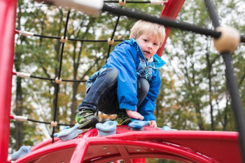 Kid Boy On Climbing Structure Kid Boy On Climbing Structure