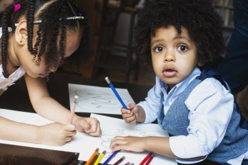 Kids Coloring At Table Kids Coloring At Table