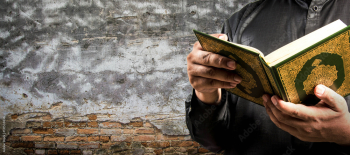 Koran in hand - holy book of Muslims ( public item of all muslims )
