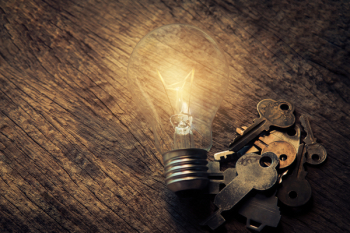 Light Bulb and Keys on Table Light Bulb and Keys on Table