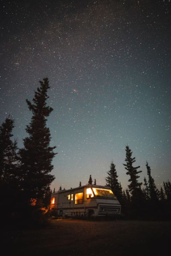 lighted white recreational vehicle into the woods lighted white recreational vehicle into the woods