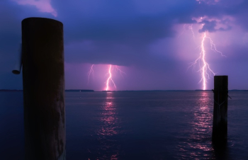 Lightning over Sea Against Storm Clouds Lightning over Sea Against Storm Clouds