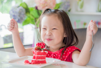 Little Asian Cute Girl Sitting Eating
