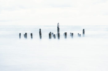 Long exposure shot of an old pier, or what's left of it. Long exposure shot of an old pier, or what's left of it.