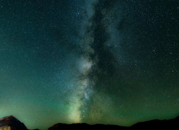 long exposure shot of stars over black mountains long exposure shot of stars over black mountains