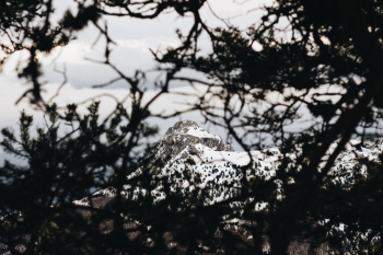 Long Shot Photo Of Snow Covered Mountain Peak Under Gray Cloudy Skies Long Shot Photo Of Snow Covered Mountain Peak Under Gray Cloudy Skies