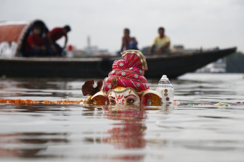 Lord Ganesha Statuette Submerged on Body of Water Lord Ganesha Statuette Submerged on Body of Water