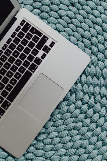 MacBook Laptop on a blue pouf MacBook Laptop on a blue pouf