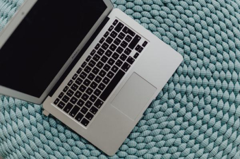 MacBook Laptop on a blue pouf MacBook Laptop on a blue pouf