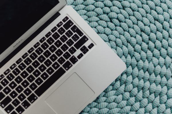 MacBook Laptop on a blue pouf MacBook Laptop on a blue pouf