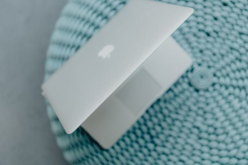 MacBook Laptop on a blue pouf MacBook Laptop on a blue pouf