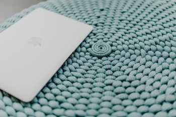 MacBook Laptop on a blue pouf MacBook Laptop on a blue pouf