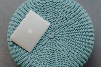 MacBook Laptop on a blue pouf MacBook Laptop on a blue pouf
