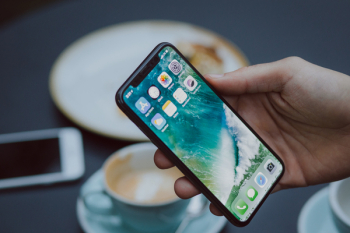 Male holding an iPhone X Male holding an iPhone X