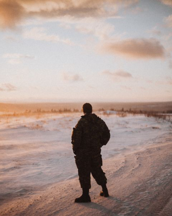 male soldier standing on sand dunes male soldier standing on sand dunes