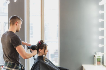Male Stylist Cutting Hair At Salon Male Stylist Cutting Hair At Salon