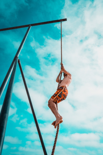 Man About to Climb Using Brown Rope Man About to Climb Using Brown Rope
