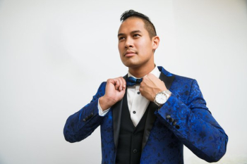 Man Adjusts Blue Tuxedo Bowtie Man Adjusts Blue Tuxedo Bowtie