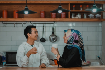 Man and Woman Drinking Tea in Kitchen Man and Woman Drinking Tea in Kitchen