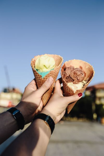 Man and Woman Holding Ice Creams Man and Woman Holding Ice Creams