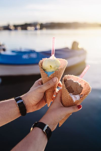 Man and Woman Holding Ice Creams Man and Woman Holding Ice Creams