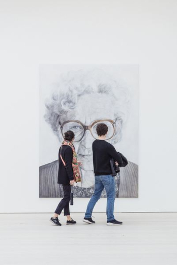 man and woman looking at woman's painting man and woman looking at woman's painting