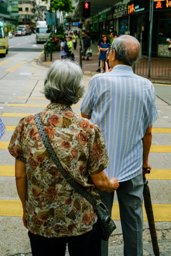 Man and Woman Standing Beside Pedestrian Lane Man and Woman Standing Beside Pedestrian Lane