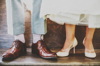 man and woman standing on wooden platform man and woman standing on wooden platform