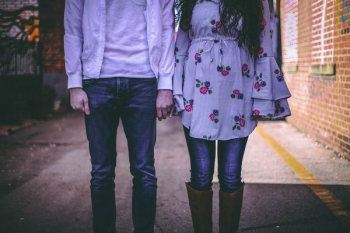 man and woman standing side by side man and woman standing side by side